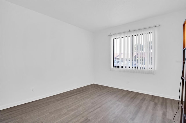 spare room with hardwood / wood-style flooring