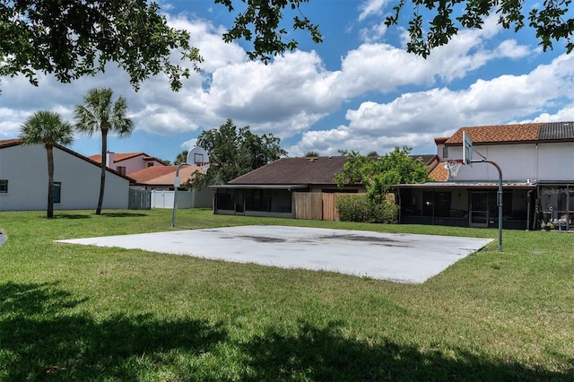 view of yard featuring basketball hoop