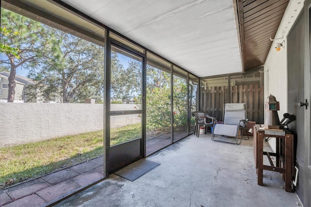 sunroom featuring vaulted ceiling