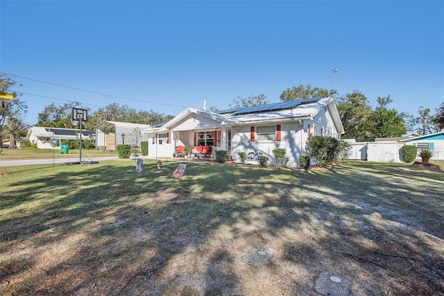 view of front of property featuring solar panels, a carport, and a front lawn