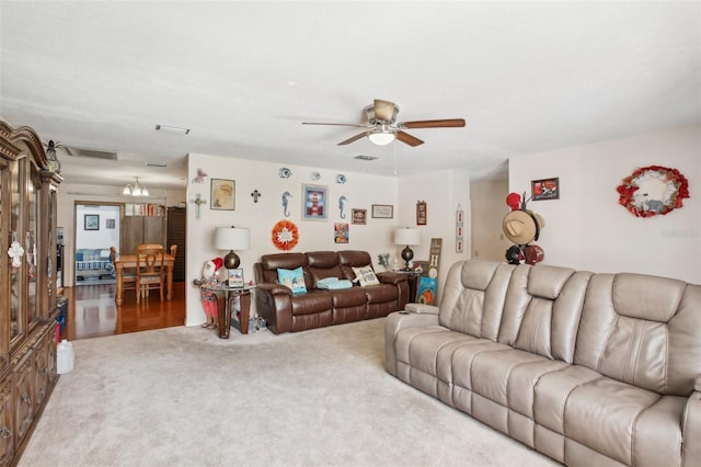 carpeted living room with ceiling fan