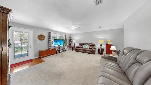 38919 3rd Ave, Zephyrhills, FL 33542 - carpeted living room with a ceiling fan and baseboards
