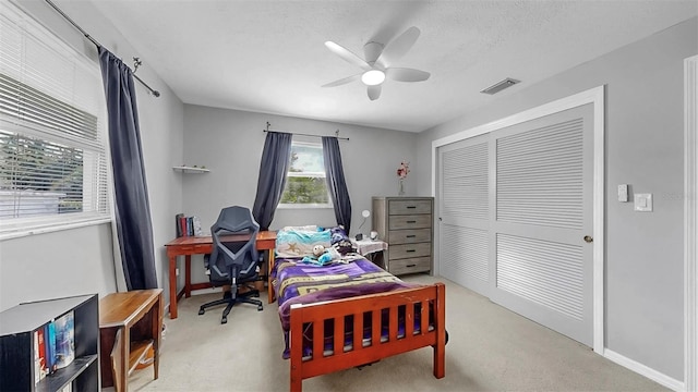 38919 3rd Ave, Zephyrhills, FL 33542 - bedroom featuring light colored carpet, a closet, a ceiling fan, and a textured ceiling
