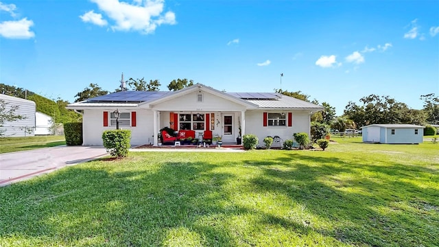 38919 3rd Ave, Zephyrhills, FL 33542 - view of front of house featuring a front yard, roof mounted solar panels, and a metal roof