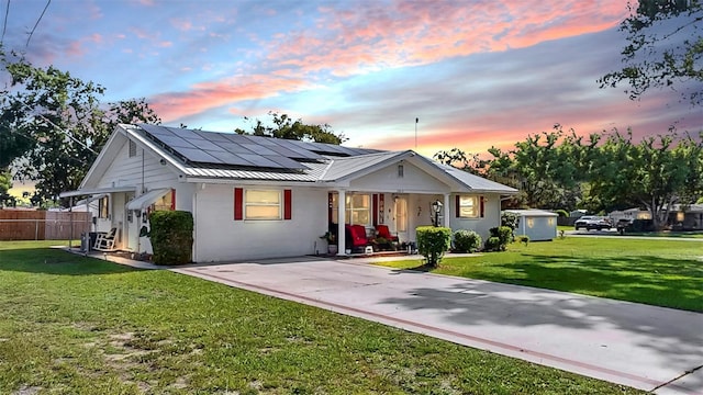 38919 3rd Ave, Zephyrhills, FL 33542 - view of front of home with a porch, roof mounted solar panels, a metal roof, a standing seam roof, and stucco siding