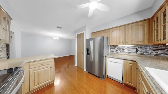 38919 3rd Ave, Zephyrhills, FL 33542 - kitchen with stainless steel fridge, dishwasher, tasteful backsplash, light wood-style floors, and light countertops