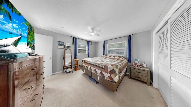 38919 3rd Ave, Zephyrhills, FL 33542 - bedroom featuring light carpet, ceiling fan, and a closet