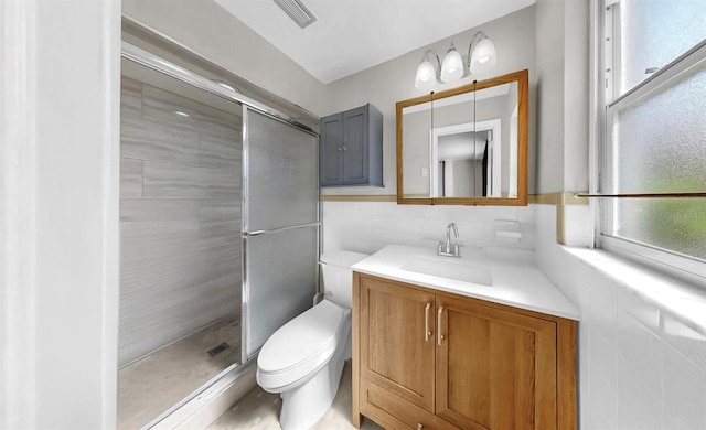 38919 3rd Ave, Zephyrhills, FL 33542 - full bathroom featuring a shower stall, vanity, and tile walls
