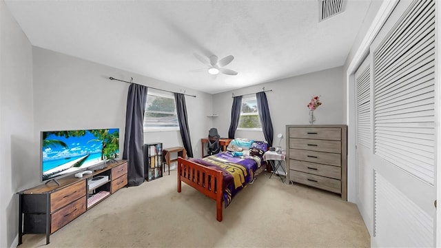 38919 3rd Ave, Zephyrhills, FL 33542 - bedroom with light colored carpet, a closet, and a ceiling fan
