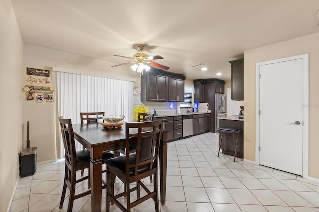 tiled dining space with ceiling fan