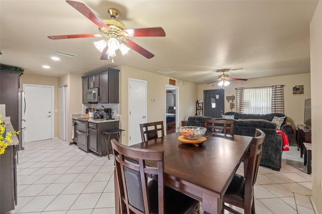 dining room featuring ceiling fan and light tile patterned floors