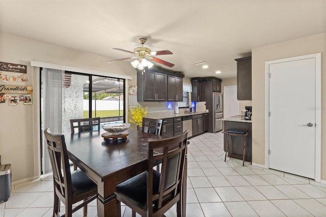 dining area featuring ceiling fan and light tile patterned floors