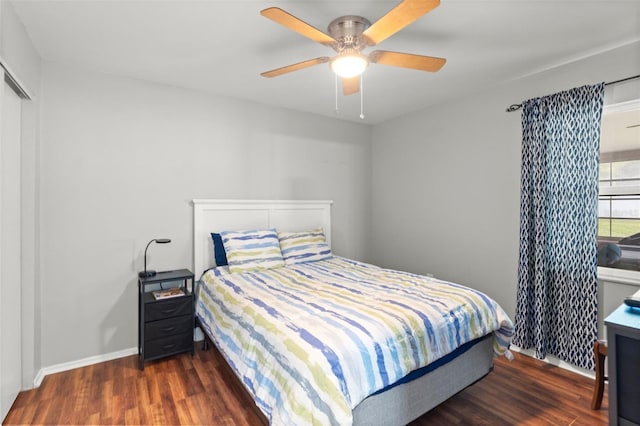 bedroom with dark hardwood / wood-style floors and ceiling fan