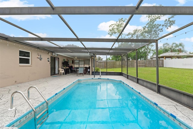 view of pool featuring a yard, a patio area, and a lanai