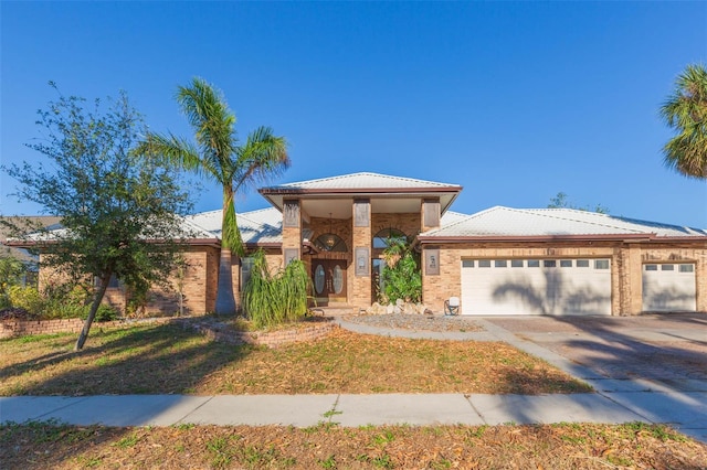 view of front of property with a front yard and a garage