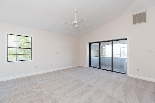 unfurnished room with ceiling fan, light colored carpet, and vaulted ceiling