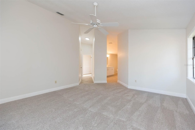 carpeted spare room with ceiling fan