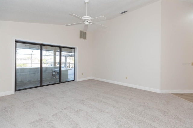 carpeted spare room with vaulted ceiling and ceiling fan