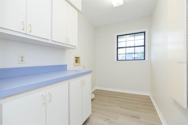 interior space featuring light hardwood / wood-style floors, cabinets, and hookup for a washing machine