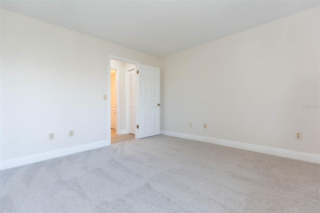 empty room featuring light carpet