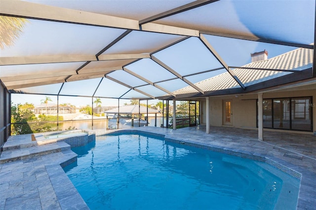 view of pool featuring an in ground hot tub, a patio, and glass enclosure