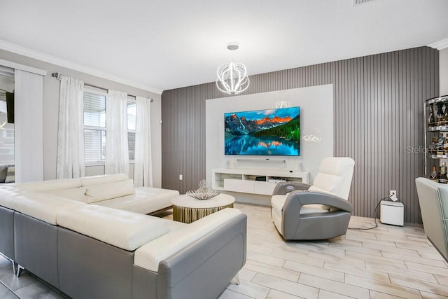 living room featuring light hardwood / wood-style floors, crown molding, and a chandelier