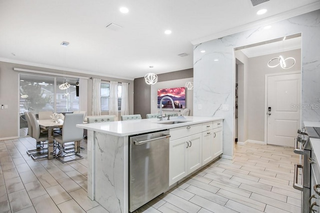 kitchen featuring white cabinets, sink, ornamental molding, decorative light fixtures, and stainless steel appliances