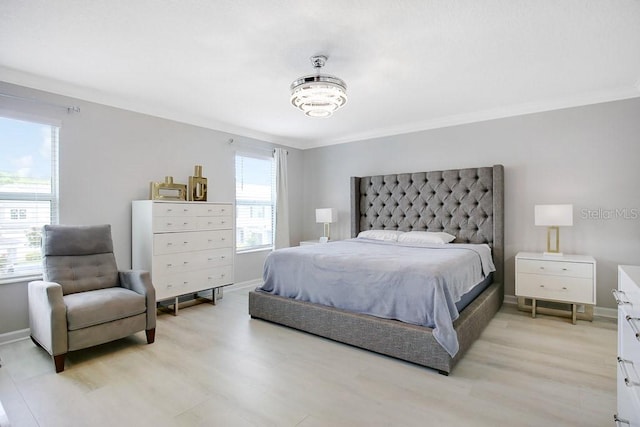 bedroom featuring light hardwood / wood-style flooring, multiple windows, and ornamental molding