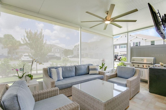 sunroom / solarium featuring ceiling fan