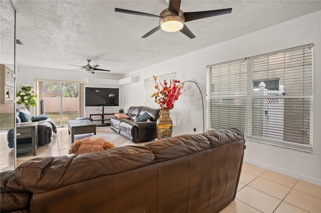 tiled living room featuring ceiling fan and a textured ceiling