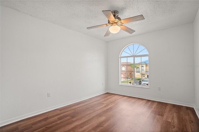 unfurnished room with hardwood / wood-style flooring, ceiling fan, and a textured ceiling