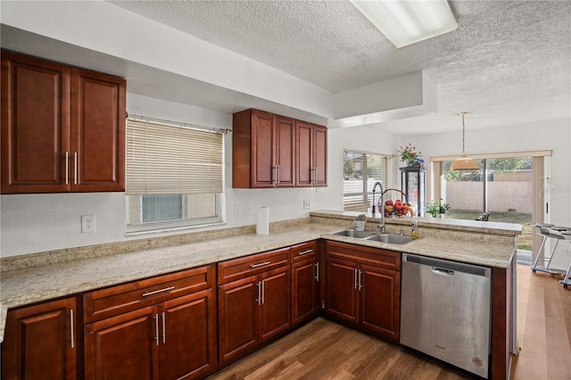 kitchen featuring dishwasher, sink, pendant lighting, and kitchen peninsula