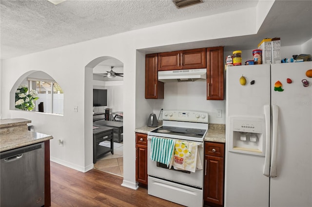 kitchen featuring dark hardwood / wood-style flooring, ceiling fan, a textured ceiling, and white appliances