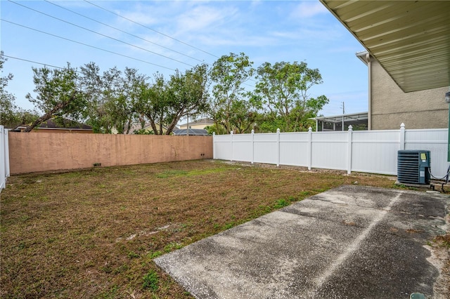 view of yard featuring central AC unit and a patio area