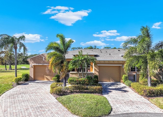 ranch-style house with a front yard and a garage