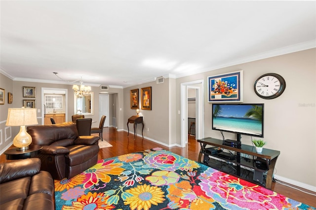 living room featuring a notable chandelier, dark hardwood / wood-style floors, and ornamental molding