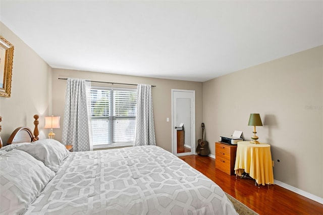 bedroom with dark wood-type flooring