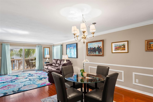 dining space with a chandelier, dark wood-type flooring, and ornamental molding