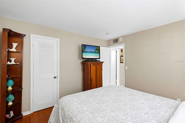 bedroom featuring a closet and dark hardwood / wood-style floors