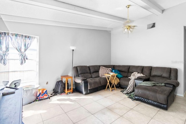 living room featuring light tile patterned floors and beamed ceiling