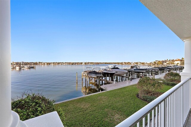 dock area with a water view and a yard