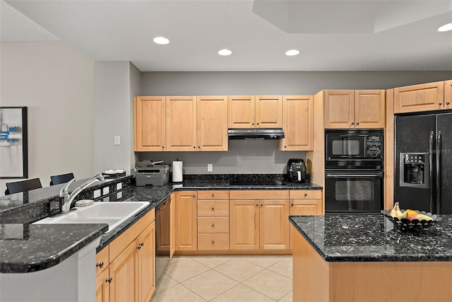 kitchen with black appliances, light brown cabinets, and dark stone countertops