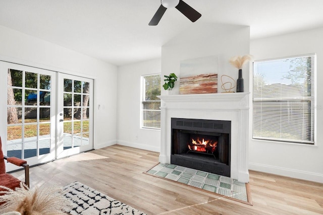 unfurnished living room featuring light hardwood / wood-style flooring, french doors, and ceiling fan