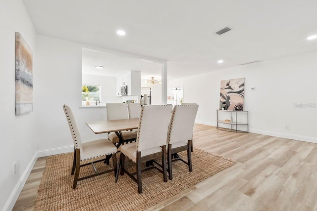 dining area with light hardwood / wood-style flooring