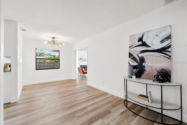 interior space with light hardwood / wood-style flooring and a notable chandelier