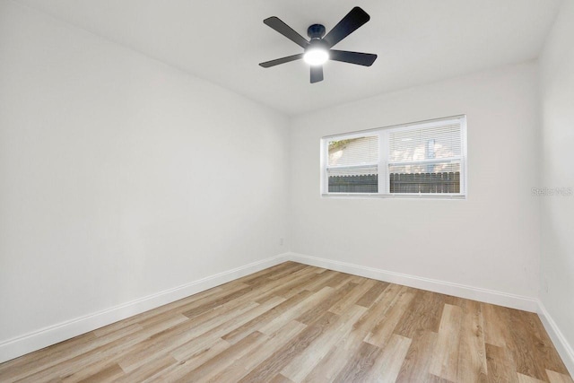 empty room with ceiling fan and light hardwood / wood-style floors