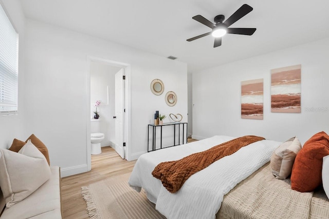 bedroom featuring ensuite bathroom, light wood-type flooring, and ceiling fan