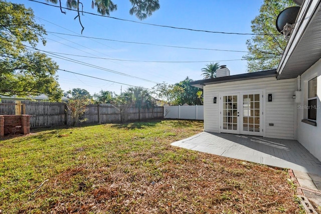 view of yard with french doors and a patio area