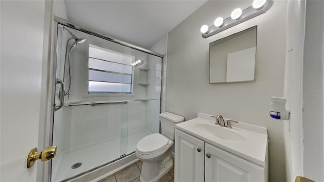 bathroom with tile patterned floors, vanity, toilet, and an enclosed shower