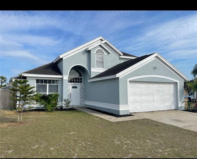 view of front facade with a garage and a front yard